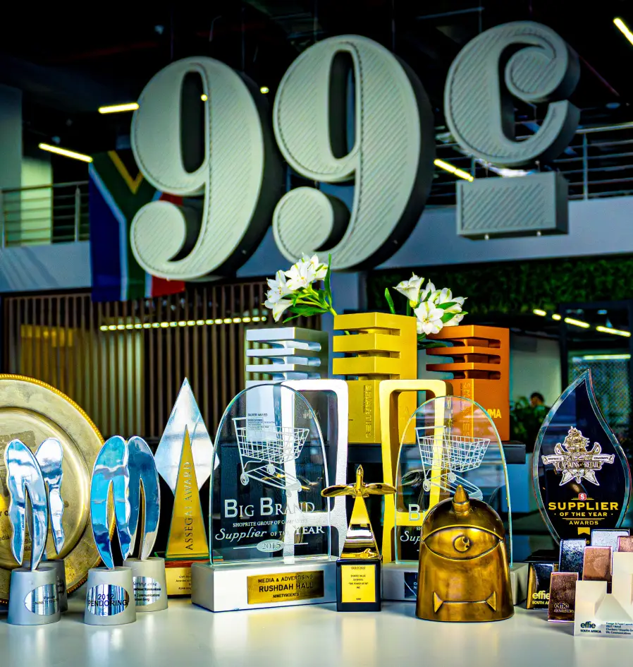 A table filled with an array of trophies and awards, representing accomplishments and recognition for 99c Agency.